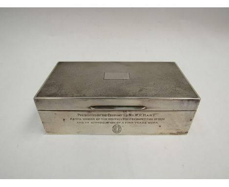 A Mappin &amp; Webb silver cigarette box, the engine-turned lid with vacant cartouche over a personalised engraved front and 