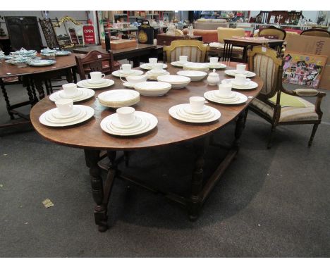 An oak gate-leg dining table on turned legs with stretcher base, approx. 74cm tall x 200cm long x 122cm wide