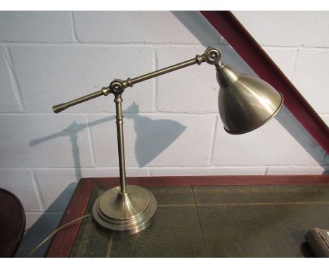 A brass effect articulated desk lamp