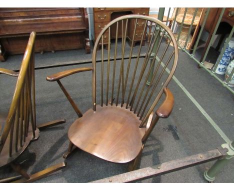 A pair of dark Ercol rocking chairs