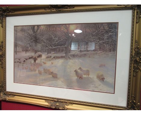 A large ornate gilt framed print depicting a snow covered field and sheep 43 x 73.5cm