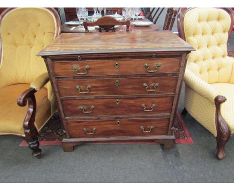 A mid-18th Century mahogany bachelors chest of four graduating drawers with canted front corners and brushing slide on bracke