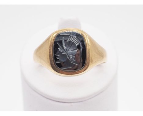 A 9ct yellow gold Roman Hermatite design signet ring, size V + 1/2, approx weight 4.2grams