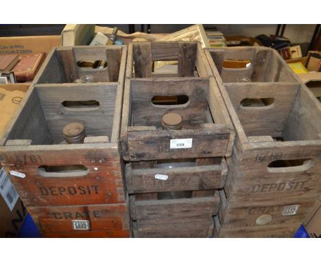 Three vintage wooden bottle crates and demi johns