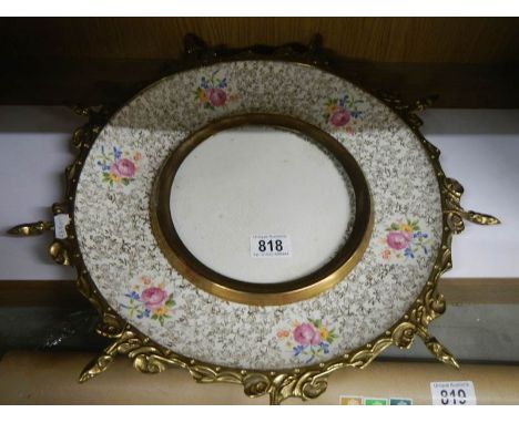 A Victorian brass and ceramic wall plaque.