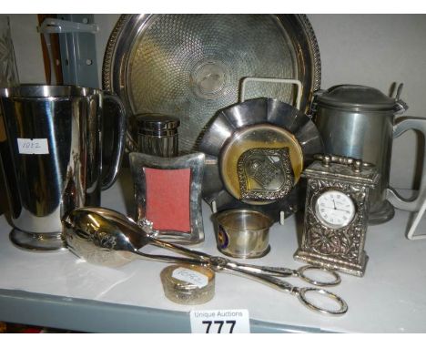 A mixed lot of plated items including tray, tongs, clock etc.,