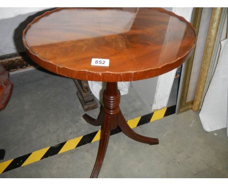 A clean mid 20th century mahogany tripod table.