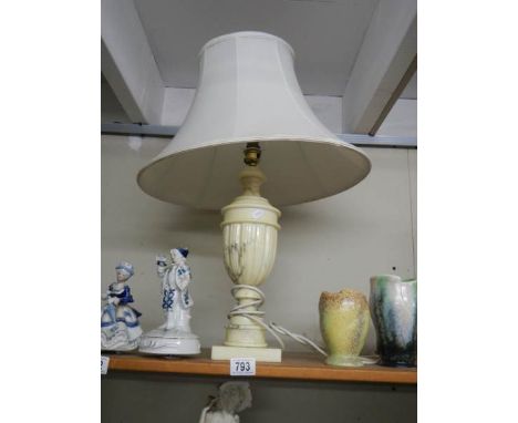 A heavy table lamp with shade.
