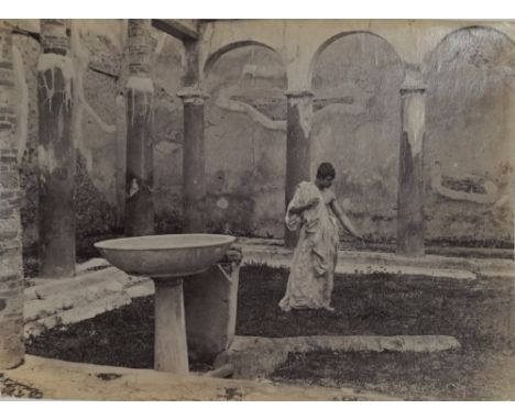 BARON VON GLOEDEN  (1856 - 1931)  Taormina, young man wearing robe, ca. 1900s, albumen print, numbered 1072 '03 in pencil, ph