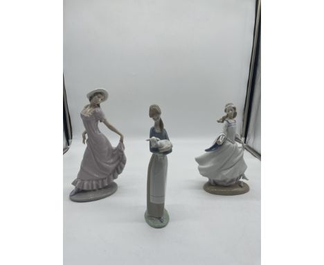 One NAO and Two Lladro Lady Figurines. 