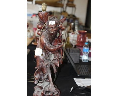 Chinese carved and stained wood figure of a flower seller, converted to an electric lamp, shrinkage cracks