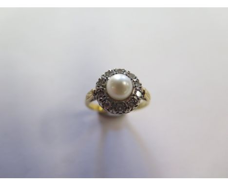 An 18ct yellow gold pearl and diamond ring, size M, marked 18ct, head approx 11mm diameter, approx 4.4 grams, slight abrasion