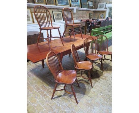 A modern cherrywood draw leaf table on turned legs with 6 ash and elm stick back chairs with crinolene stretchers, table 79cm