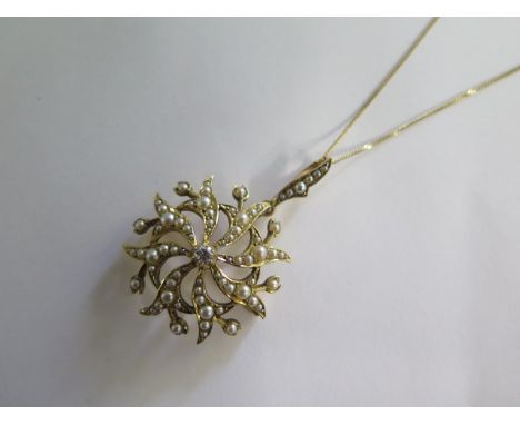 A 15ct gold Edwardian pearl and diamond pendant / brooch on a modern 18ct yellow gold 46cm chain, pendant 25mm diameter, in g
