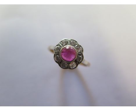 An 18ct yellow gold and platinum cabouchon ruby / spinnel and diamond daisy ring, size M/N, head 10mm diameter, approx 2.6 gr