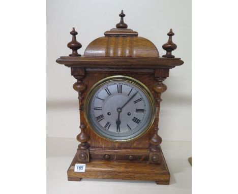 An 8 day oak case striking bracket clock, 50cm tall, with key and running 