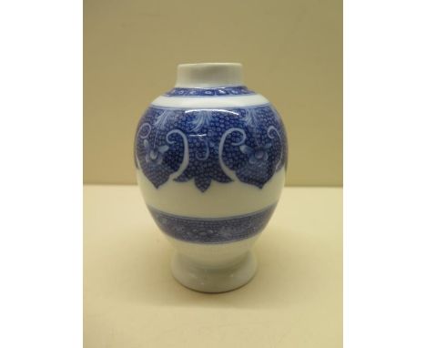 A Chinese soft paste porcelain tea caddy decorated in a blue and white scale and floral design, 12cm tall, good condition 