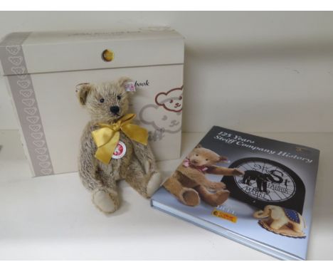 A boxed Steiff teddy bear with book 125 years of Steiff, dust sheet ripped to book, cinnamon bear 25cm tall 