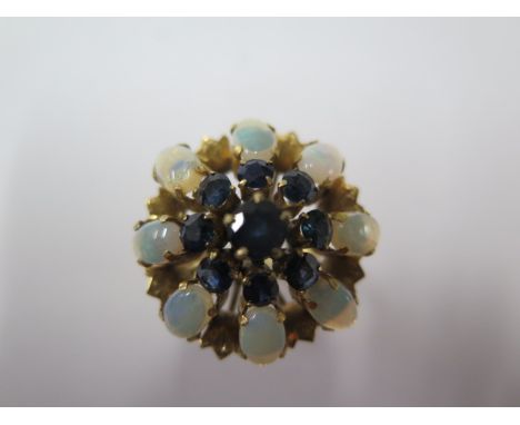 A yellow gold opal and sapphire cluster ring, size P/Q, head approx 25mm diameter, hallmarks worn, tests to approx 9ct, gener