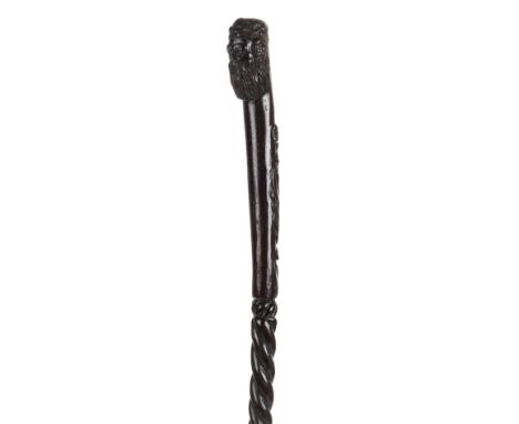 *Walking Stick. 19th century folk art wooden walking stick carved from a single piece,  the knop carved with the head of Bacc