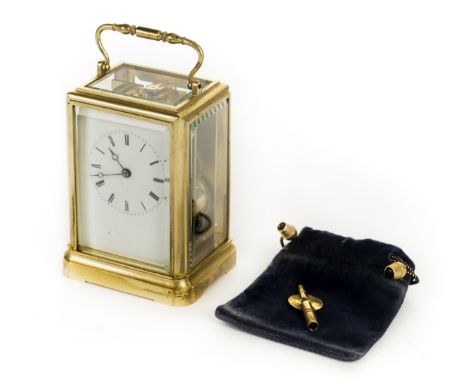 *Carriage Clock. A 20th century brass carriage clock,  the white enamel dial with black roman numerals, platform escapement a
