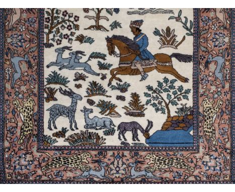 *Rug. A modern Persian woollen rug,  with a figure on horseback and wild animals, including an elephant, leopards and deers o