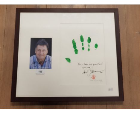 A FRAMED SIGNATURE AND HAND PRINT BY ALAN TITCHMASH ACCOMPANIED WITH A PHOTOGRAPH OF THE MAN HIMSELF
