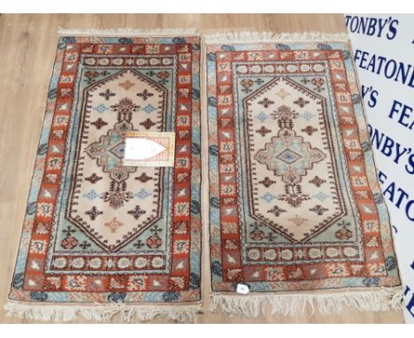 PAIR OF GENUINE HANDMADE FRINGED TURKISH WOOL RUGS IN A TRADITIONAL STYLE , 77CM X 124CM WITH CERTIFICATE OF AUTHENTICITY FRO