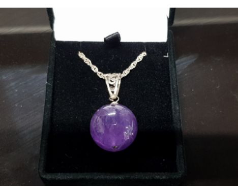 A LARGE AMETHYST BEAD AND SILVER PENDANT AND CHAIN STAMPED 925