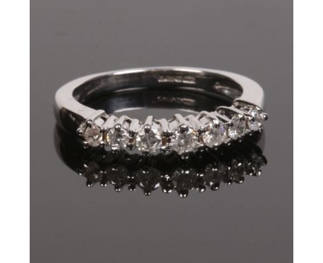 An 18 carat white gold and diamond seven stone half eternity ring. Centre stone approximately 0.12ct. Size S.Condition report