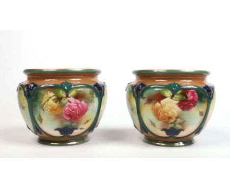 A pair of Royal Worcester cache pots by C. Tisdale. With moulded cartouches containing painted roses. Signed, printed green m