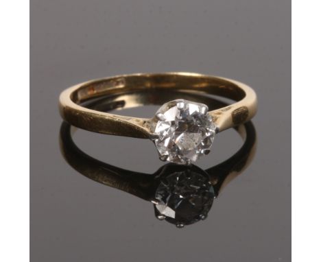 An 18 carat gold and platinum solitaire diamond ring. Set with a round cut stone approximately 0.7ct, size L.Condition report