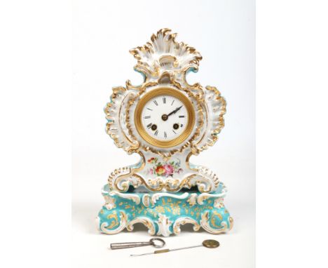 A 19th century French china cased mantel clock on stand. Housing an 8 day silk suspension movement striking on a bell. The ca