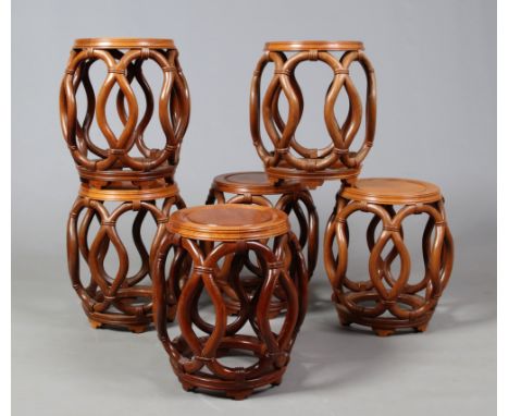 A set of six 20th century Chinese hardwood barrel stools. With carved openwork sides and raised on bracket feet, 45cm.