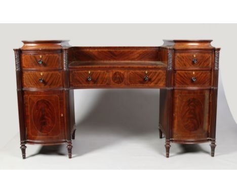 A 19th century large mahogany twin pedestal sideboard. Each bow fronted caddy top pedestal has reeded and twist column suppor