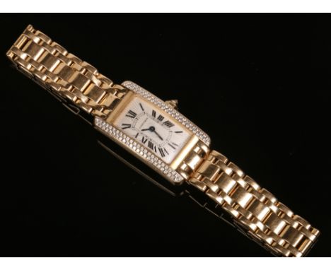 *Not as originally catalogued. A ladies Cartier tank Americaine quartz 18 carat gold bracelet watch. With engine turned engra