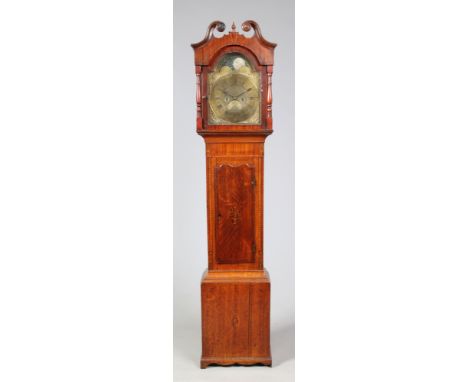 A George III oak and mahogany eight day longcase clock with marquetry patera and banding. With brass arch top dial incorporat