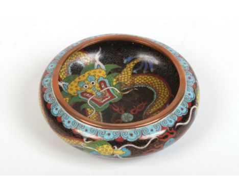 A Chinese copper and cloisonne enamel bowl. Black ground and decorated with yellow dragons chasing flaming pearls, 14cm diame