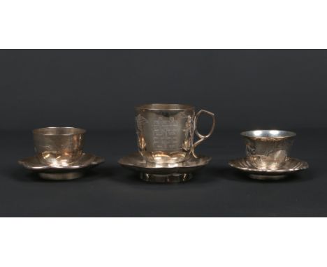 An early 20th century Chinese silver coffee cup on lobed trembleuse saucer along with two Chinese silver tea bowls and saucer