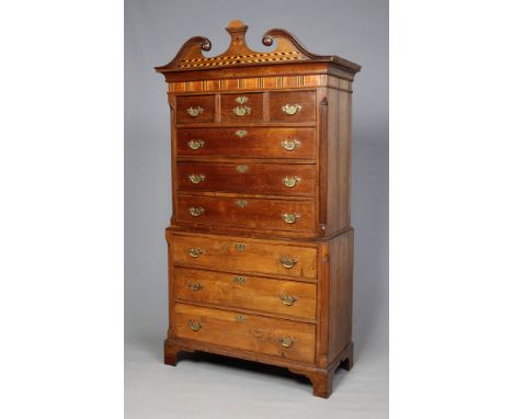 A George III oak chest on chest. With swan neck pediment inlaid with ebony and boxwood, further inlaid to the mahogany frieze
