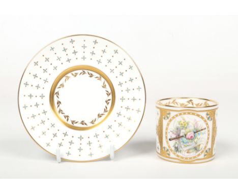 A Lynton Porcelain Company coffee can and saucer by Stefan D. Nowacki. Gilded and jeweled on a white and gold ground, painted