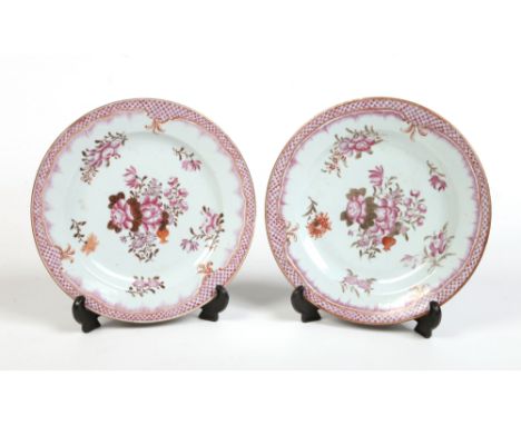 A pair of 18th century Chinese famille rose plates. With scale and feathered borders and decorated with peony bouquets, 23cm 