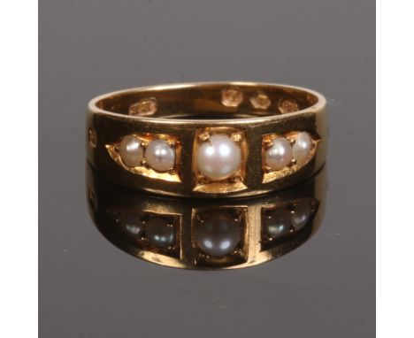 A Victorian 18 carat gold ring set with five seed pearls. Assayed London 1886, size K.