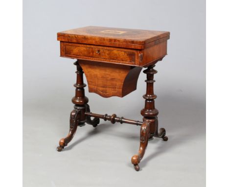 A Victorian figured mahogany games table. With Killarney work inlaid top depicting a castle, the fold over top revealing a ch