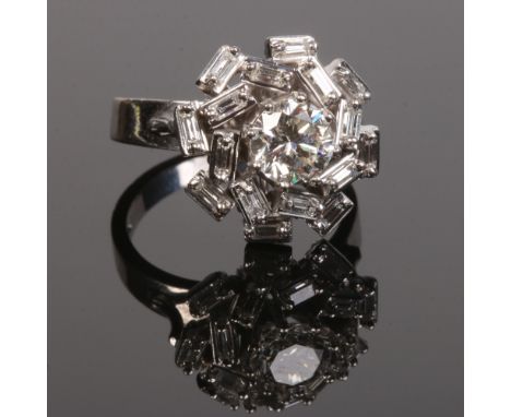 An 18 carat white gold diamond cluster ring. Set with a brilliant cut principle diamond approximately 1.1ct surrounded by two