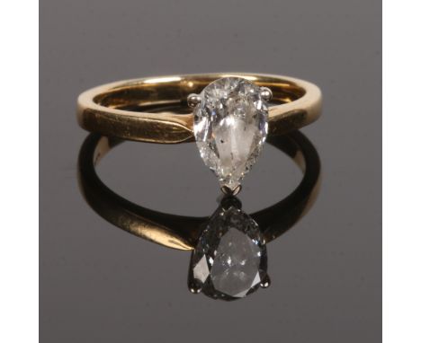 An 18 carat gold diamond solitaire ring. Set with a pear cut diamond 6mm x 9mm. Size L.Condition report intended as a guide o