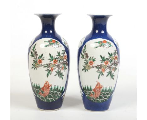 A pair of 19th century Chinese famille verte ovoid shaped vases. Powder blue ground and painted in reserves with prunus bloss