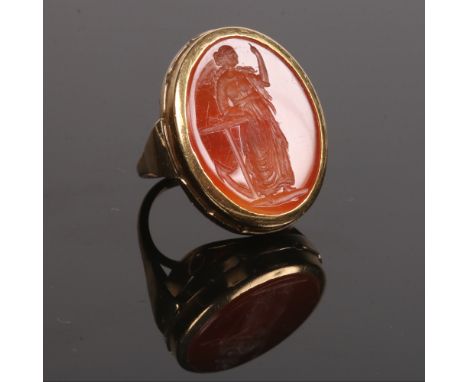 A 9 carat gold carnelian intaglio signet ring. Allegorical of hope, formed as a maiden leaning against an anchor. Stone 23mm 