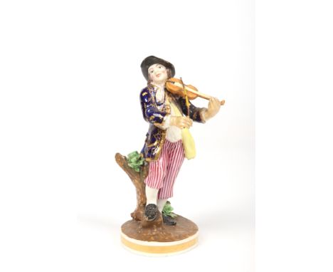 A Derby Bloor period figure of a violin player. Wearing a cobalt blue and gold overcoat raised on a naturalistic base over a 