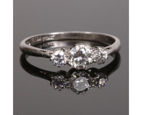 An 18 carat white gold and platinum three stone diamond ring. Set with brilliant cut diamonds, centre approximately 0.5ct fla